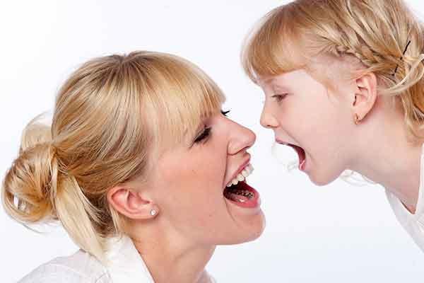 Mum showing child lingual braces