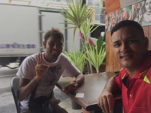 Dnyan and new friend, Gyan, pose for a selfie together at a restaurant.