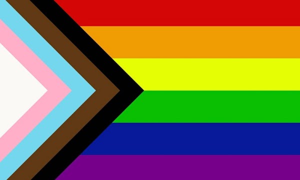 The newer LGBTQ+ flag design that includes black, brown, pink, white and blue stripes in a right angle pointing to the center of the rainbow flag.