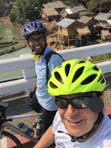 Dnyan and Jeff posing for a selfie together on bikes.