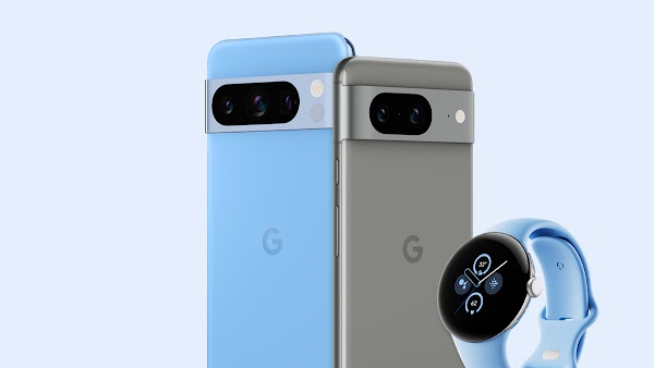 A sky blue Pixel phone stands next to a gray Pixel phone