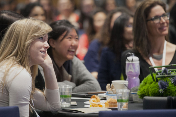 Women sitting together at a technology career conference.