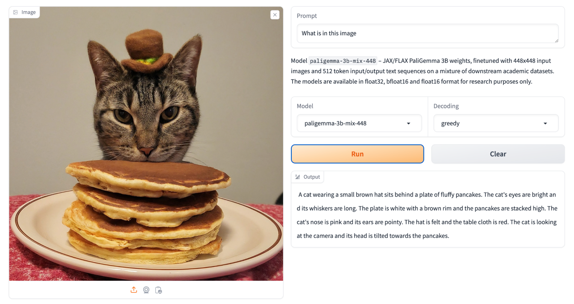 Screenshot from the HuggingFace Space running PaliGemma showing an image of a cat wearing a tiny hat, with his head on stack of four pancakes